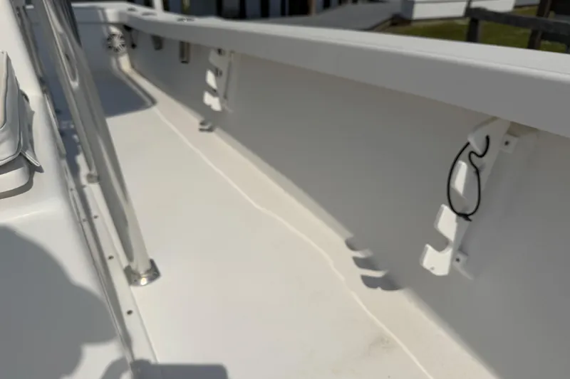 Slide: The Image of Interior view of a 2021 Intruder 23 boat, showcasing sleek white design and fixtures. - 16