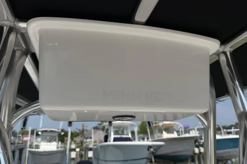 Slide: The Image of T-top of a 2021 Intruder 23 boat with Minn Kota equipment at a marina. - 17