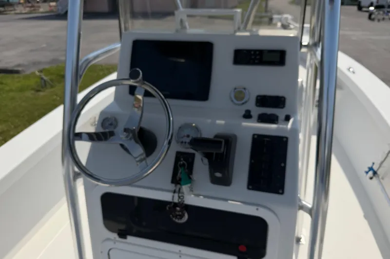 Slide: The Image of 2021 Intruder 23 boat dashboard with steering wheel and control panel. - 19