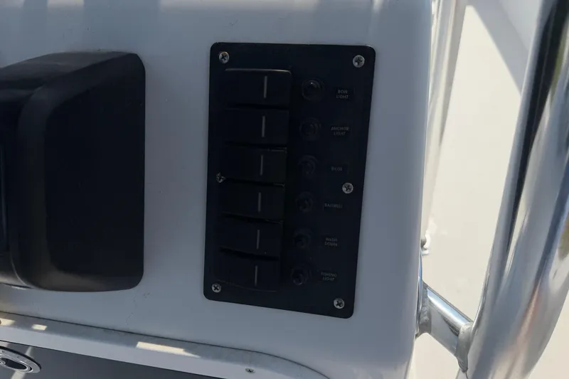 Slide: The Image of Control panel on a 2021 Intruder 23 boat, featuring labeled switches for various functions. - 20