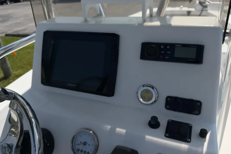 Slide: The Image of Control panel of 2021 Intruder 23 boat with navigation and audio systems. - 21