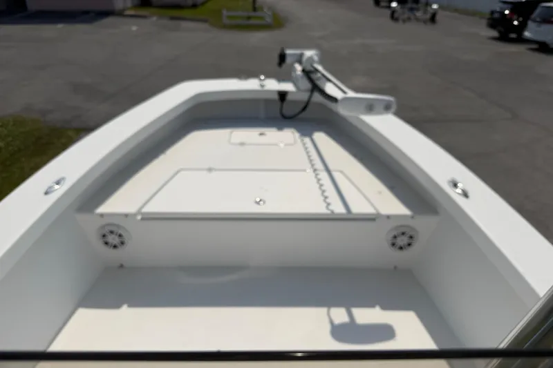 Slide: The Image of Front deck of a 2021 Intruder 23 boat with storage compartments and speakers. - 23