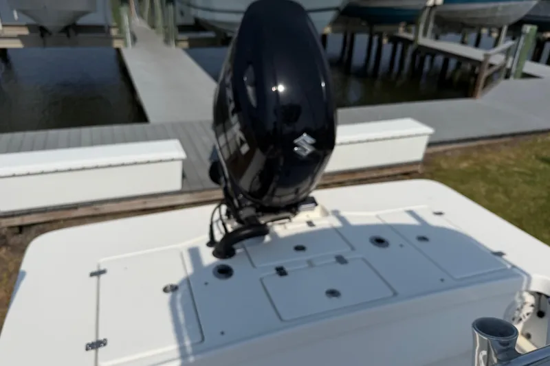Slide: The Image of 2021 Intruder 23 boat with Suzuki outboard motor at dockside. - 24