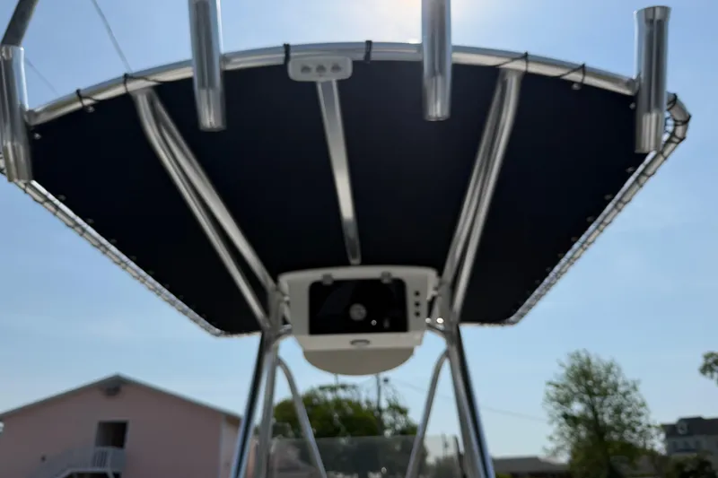 Slide: The Image of T-top of a 2021 Intruder 23 boat under clear blue sky. - 27