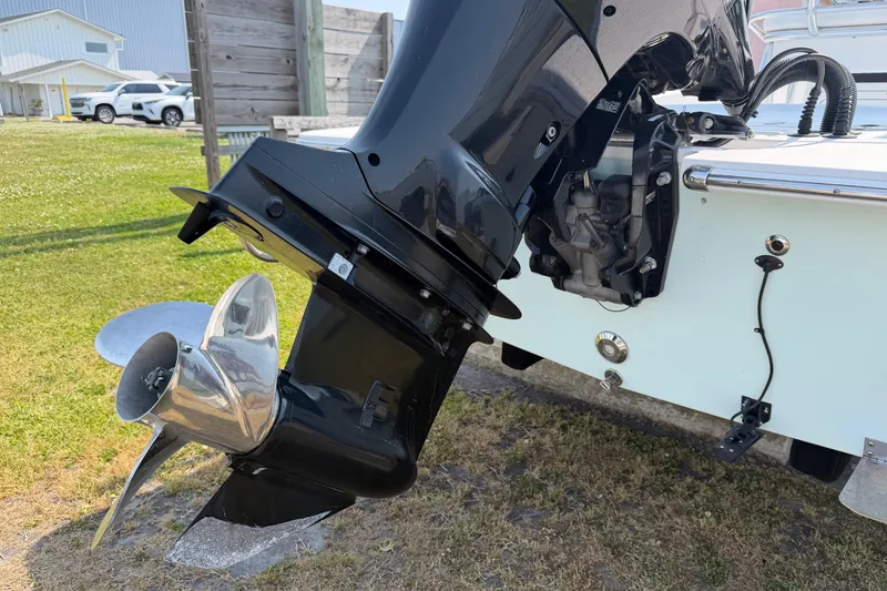 Slide: The Image of Outboard motor of a 2021 Intruder 23 boat on grass. - 31