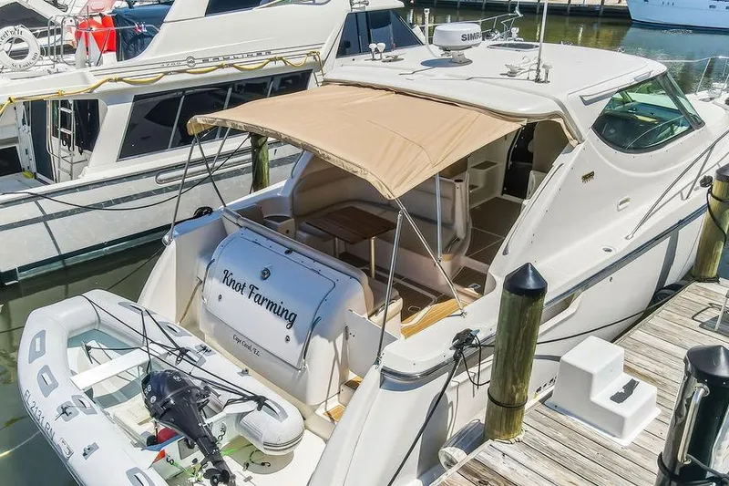 Slide: The Image of 2008 Tiara Yachts 3900 Sovran docked with canopy and dinghy. - 11