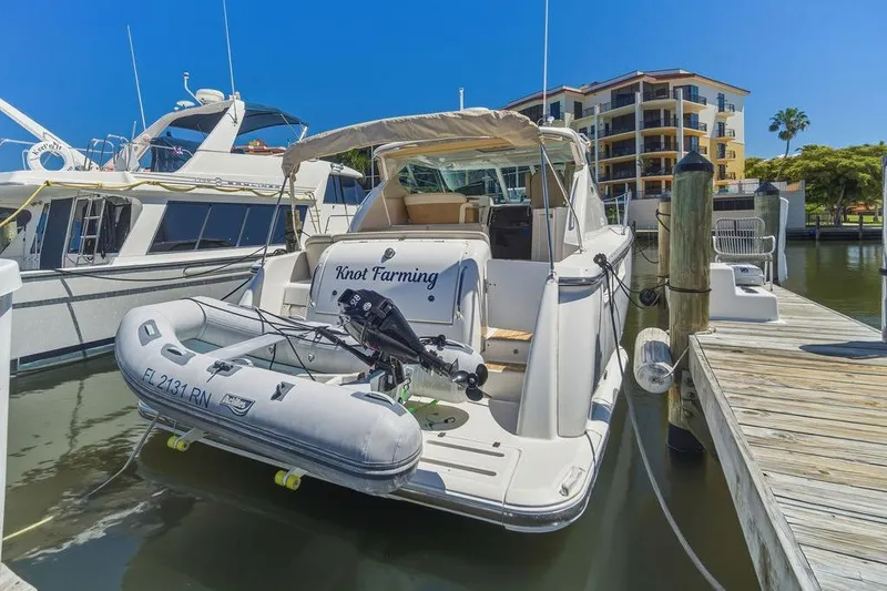 Slide: The Image of 2008 Tiara Yachts 3900 Sovran docked with inflatable boat, sunny marina setting. - 12