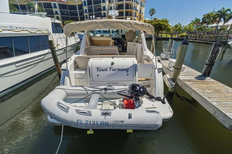 Slide: The Image of 2008 Tiara Yachts 3900 Sovran docked with inflatable boat, sunny marina setting. - 13