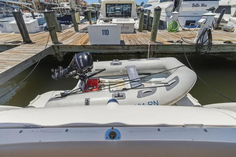 Slide: The Image of 2008 Tiara Yachts 3900 Sovran docked with inflatable boat and outboard motor. - 14