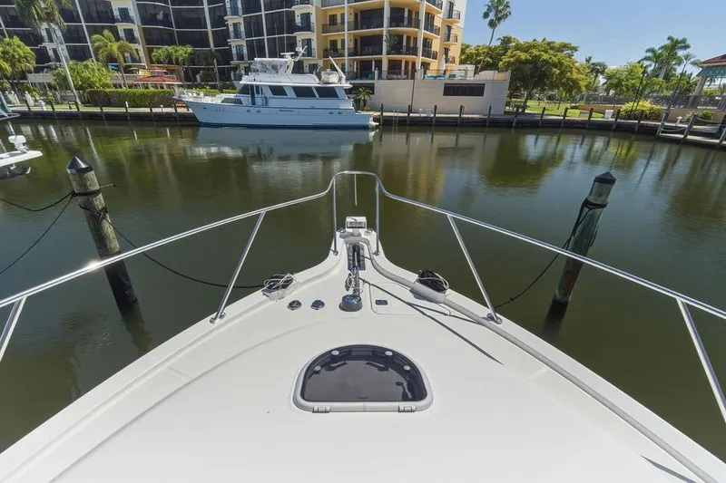 Slide: The Image of Bow view of 2008 Tiara Yachts 3900 Sovran docked in a serene marina. - 16