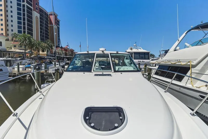 Slide: The Image of 2008 Tiara Yachts 3900 Sovran docked at marina with cityscape background. - 17