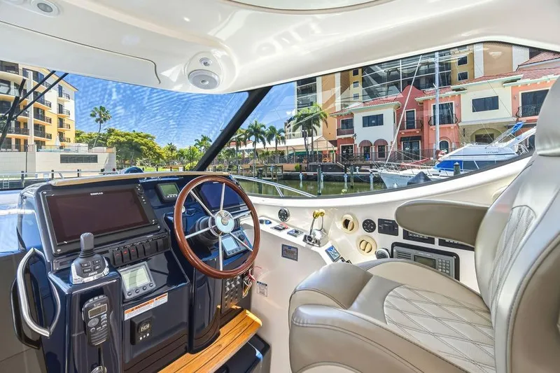 Slide: The Image of Interior view of 2008 Tiara Yachts 3900 Sovran helm with luxurious seating and modern controls. - 22