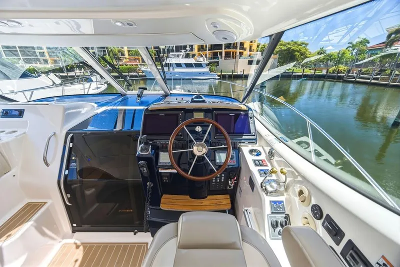Slide: The Image of Interior view of 2008 Tiara Yachts 3900 Sovran helm with modern controls and waterfront backdrop. - 25