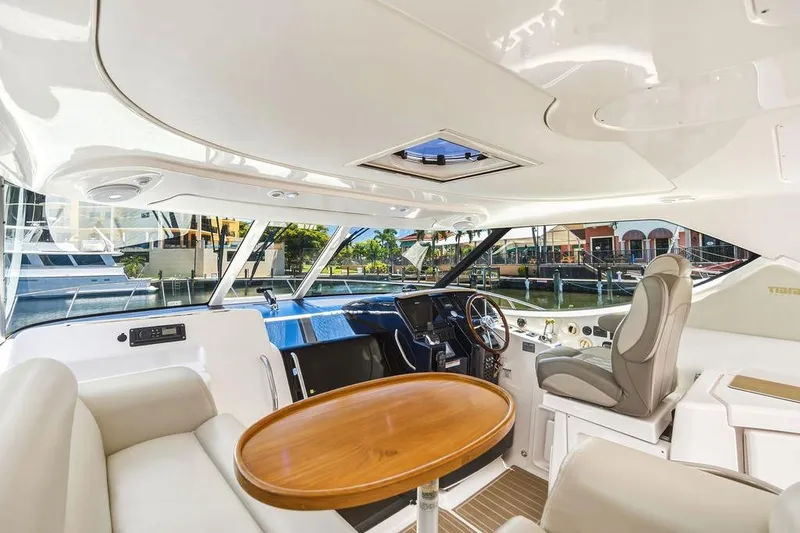 Slide: The Image of Interior of 2008 Tiara Yachts 3900 Sovran, featuring helm and seating area. - 26