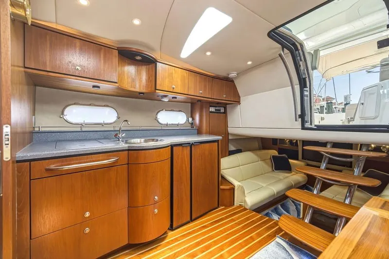 Slide: The Image of 2008 Tiara Yachts 3900 Sovran interior with wooden cabinetry and seating area. - 32