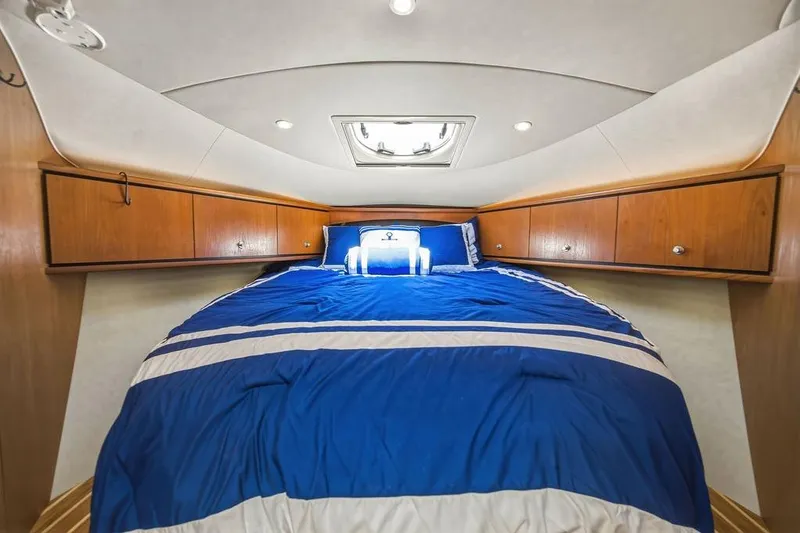 Slide: The Image of Luxurious cabin interior of 2008 Tiara Yachts 3900 Sovran with blue bedding. - 34