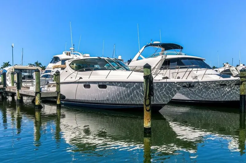 Slide: The Image of 2008 Tiara Yachts 3900 Sovran docked at marina under clear blue sky. - 4
