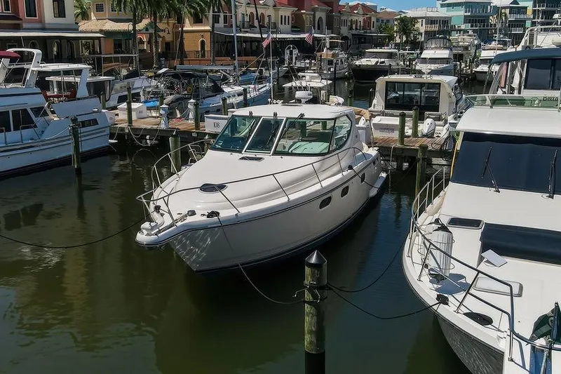 Slide: The Image of 2008 Tiara Yachts 3900 Sovran docked in a bustling marina. - 6