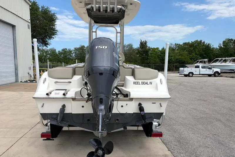 Slide: The Image of 2023 Key West 203 FS boat with Yamaha 150 engine, parked outdoors. - 10