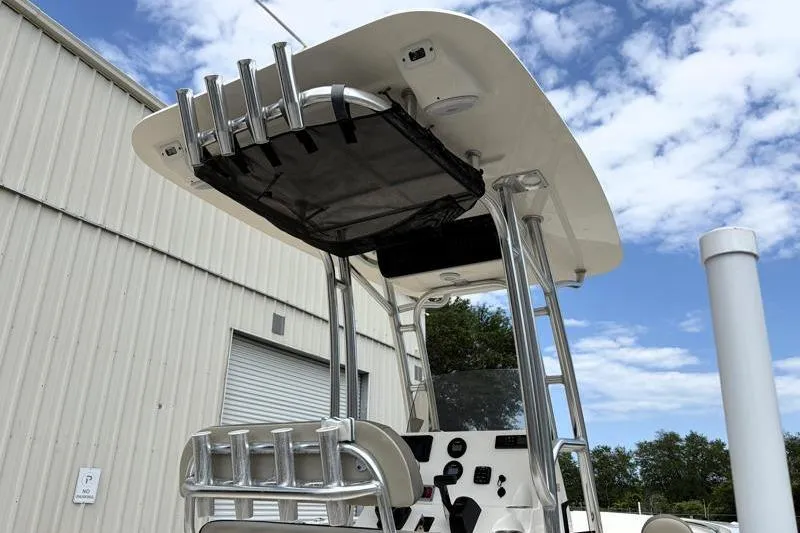 Slide: The Image of 2023 Key West 203 FS boat with T-top and rod holders, under a partly cloudy sky. - 12