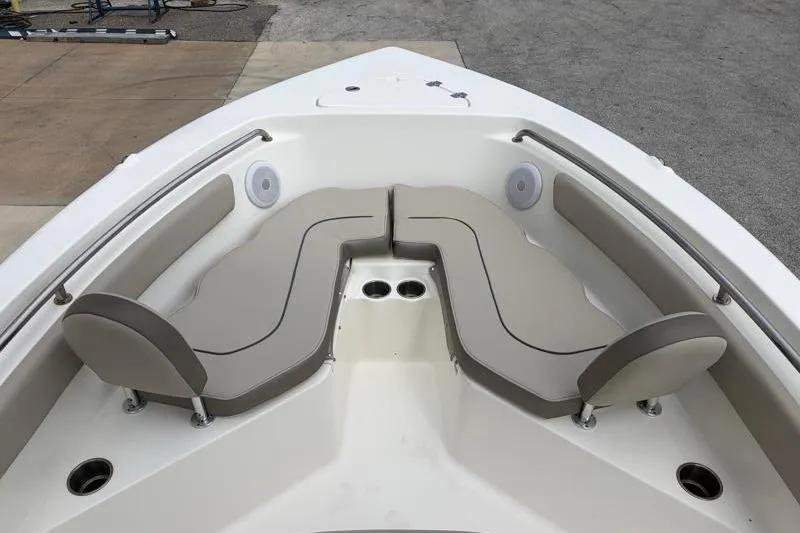 Slide: The Image of 2023 Key West 203 FS boat interior with cushioned seating and cup holders. - 14