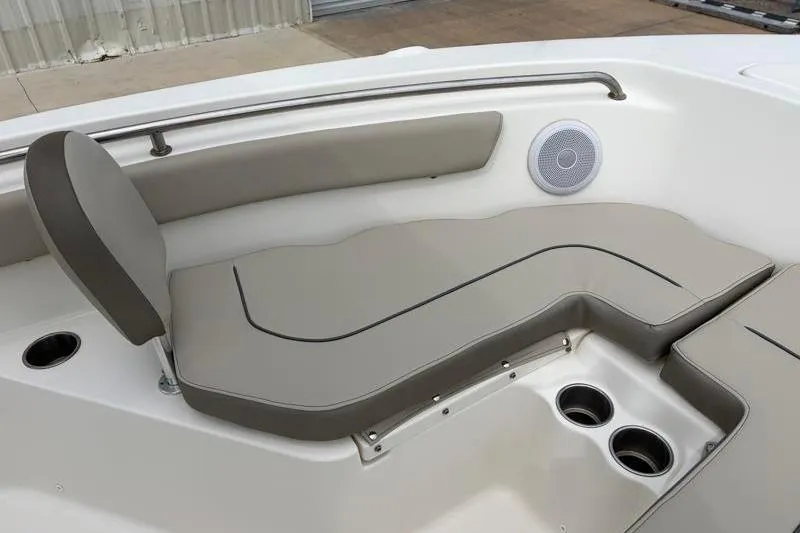 Slide: The Image of 2023 Key West 203 FS boat interior with cushioned seating and cup holders. - 17