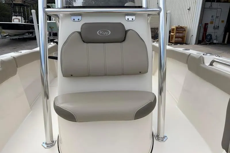 Slide: The Image of 2023 Key West 203 FS boat interior with beige seating and stainless steel frame. - 18