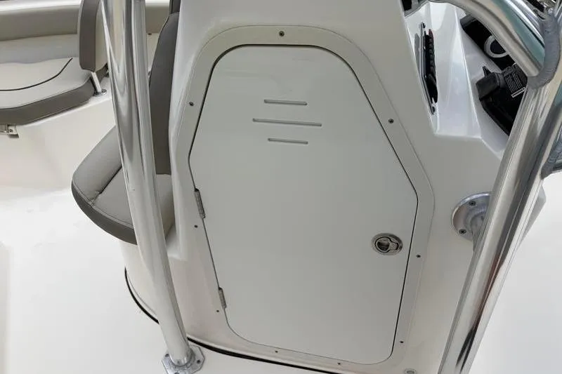 Slide: The Image of 2023 Key West 203 FS boat console with storage compartment and seating area. - 22