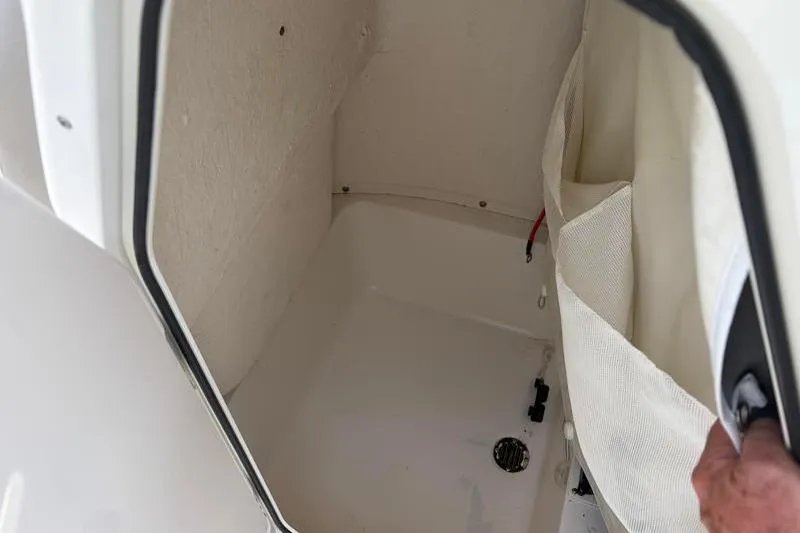 Slide: The Image of Storage compartment inside 2023 Key West 203 FS boat, featuring a clean, white interior. - 23