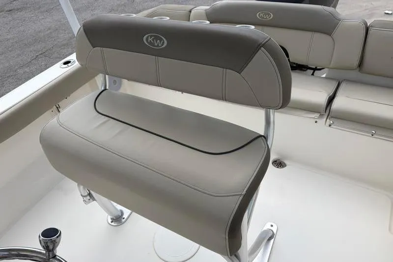 Slide: The Image of 2023 Key West 203 FS boat seating with beige upholstery and KW logo. - 24