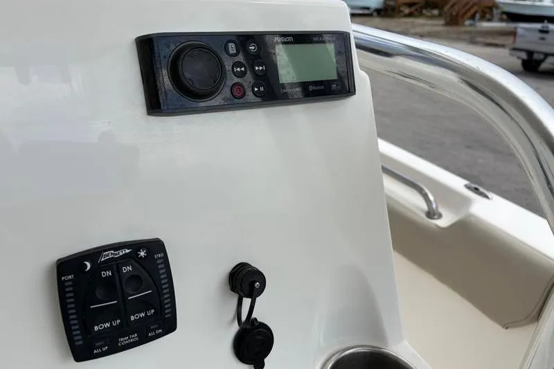 Slide: The Image of Control panel of a 2023 Key West 203 FS boat with audio and trim controls. - 27