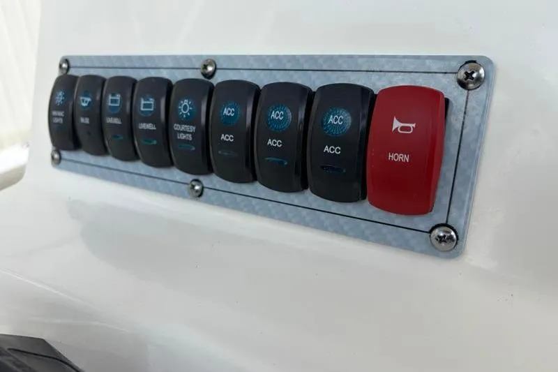 Slide: The Image of Control panel of 2023 Key West 203 FS boat with labeled switches. - 28