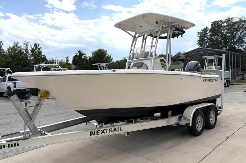 Slide: The Image of 2023 Key West 203 FS boat on NexTrail trailer, parked outdoors. - 3
