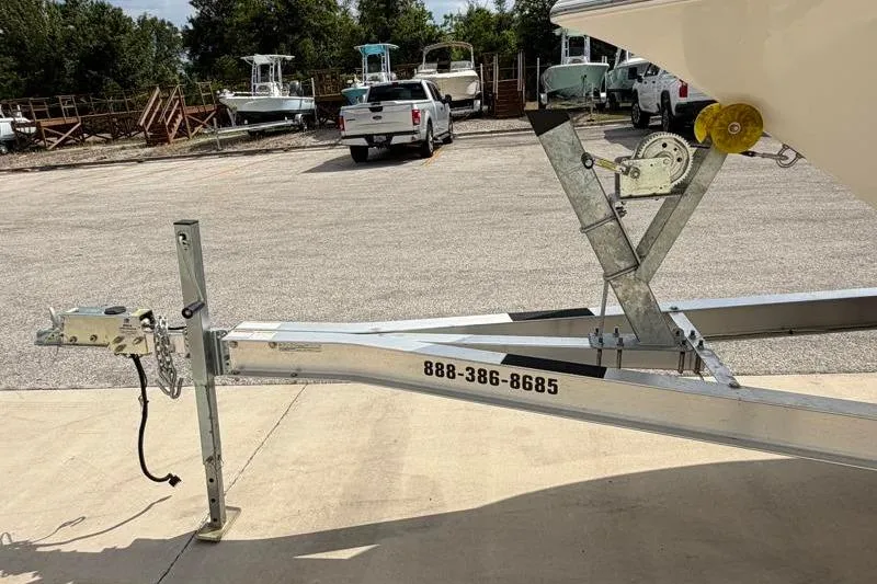 Slide: The Image of 2023 Key West 203 FS boat trailer in parking lot with contact number visible. - 40