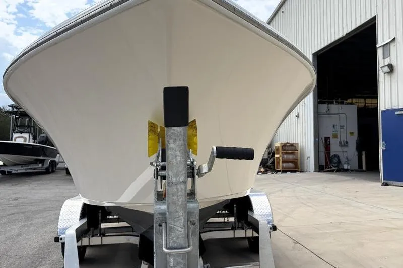 Slide: The Image of 2023 Key West 203 FS boat on trailer outside a warehouse. - 7