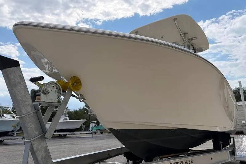 Slide: The Image of 2023 Key West 203 FS boat on trailer under a cloudy sky. - 9