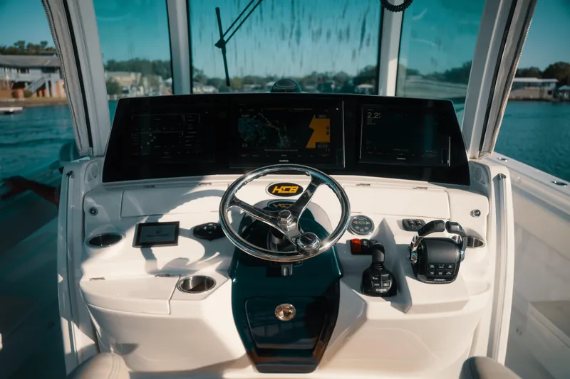Slide: The Image of Helm of 2019 HCB 42 Siesta boat with advanced navigation controls and displays. - 16