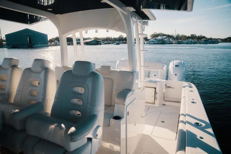 Slide: The Image of Luxurious 2019 HCB 42 Siesta boat interior with plush seating, docked by serene waters. - 18