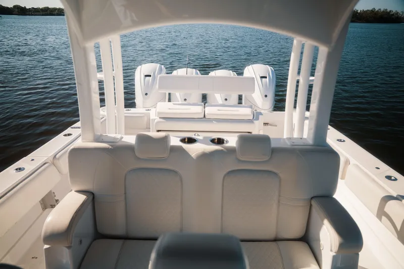 Slide: The Image of 2019 HCB 42 Siesta boat interior with luxurious seating and powerful engines on a serene lake. - 20