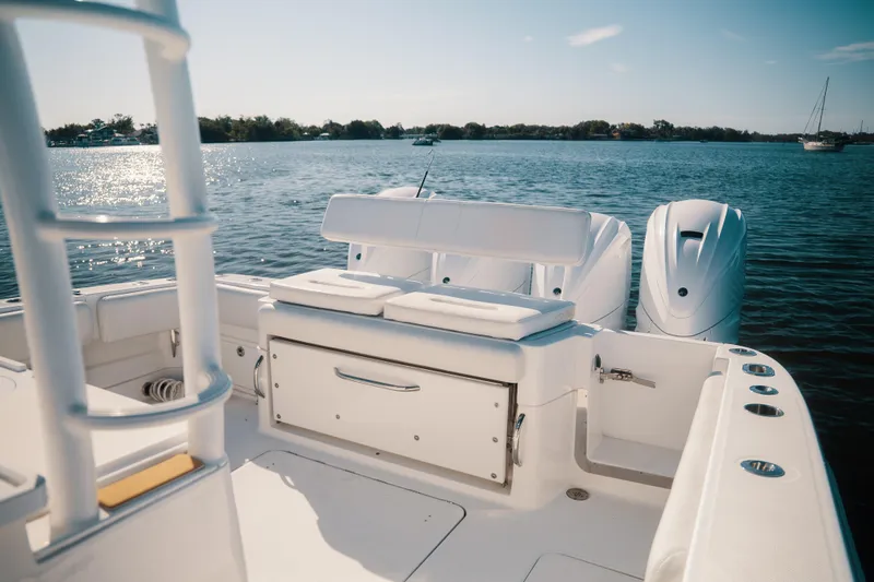 Slide: The Image of 2019 HCB 42 Siesta boat with sleek design, spacious deck, and powerful engines on calm water. - 21
