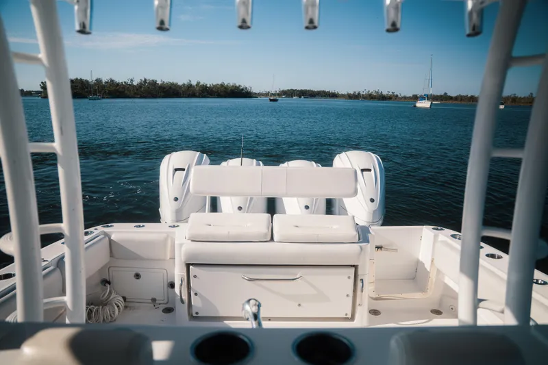 Slide: The Image of 2019 HCB 42 Siesta boat interior with triple outboard motors on calm water. - 22