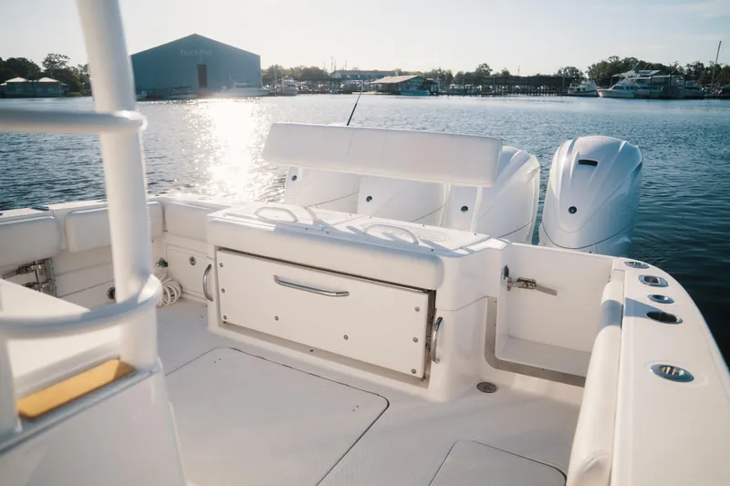 Slide: The Image of 2019 HCB 42 Siesta boat interior with dual engines, docked in sunny marina. - 23