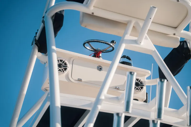 Slide: The Image of 2019 HCB 42 Siesta boat helm with steering wheel and speakers against blue sky. - 31