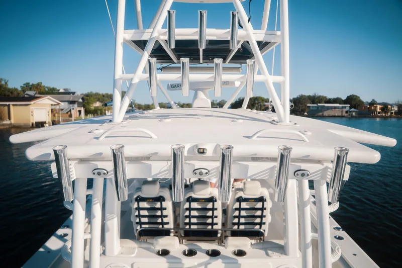 Slide: The Image of 2019 HCB 42 Siesta boat with rod holders and tower, docked on a sunny day. - 32