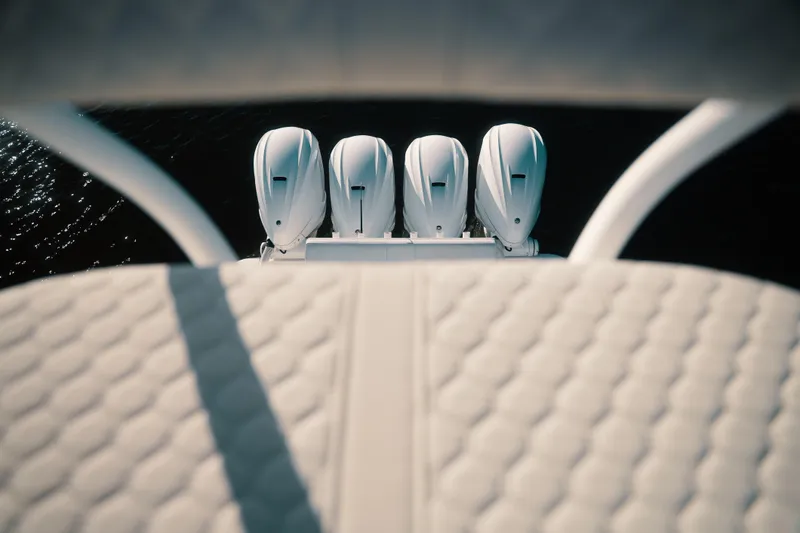 Slide: The Image of Four powerful outboard engines on a 2019 HCB 42 Siesta boat, viewed from above. - 36