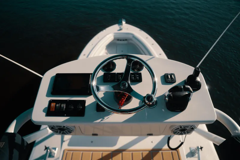 Slide: The Image of Helm of 2019 HCB 42 Siesta boat with steering wheel and controls. - 39