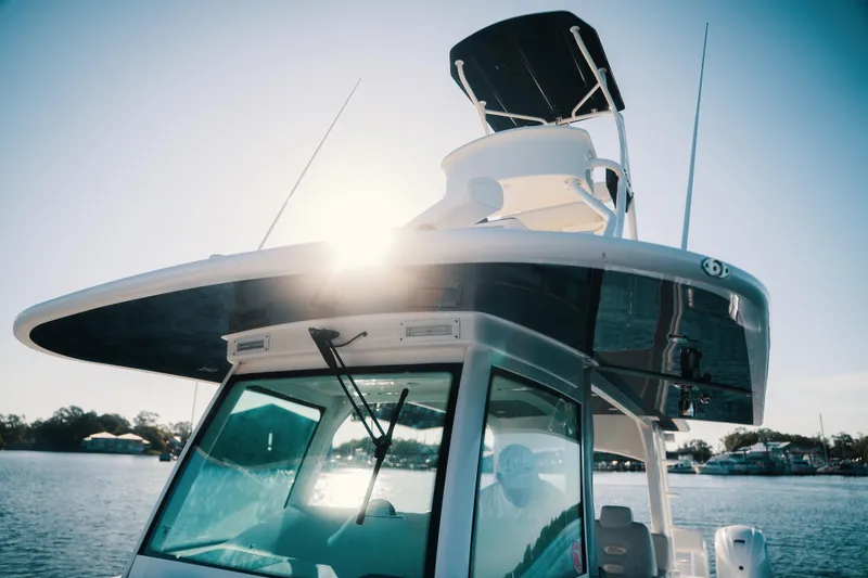 Slide: The Image of 2019 HCB 42 Siesta boat with sunlit helm, on calm water. - 4