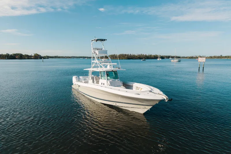 Slide: The Image of 2019 HCB 42 Siesta boat on calm water under clear blue sky. - 42