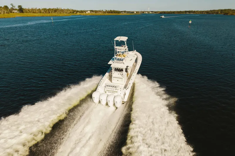 Slide: The Image of 2019 HCB 42 Siesta boat cruising on open water, leaving a wake behind. - 48