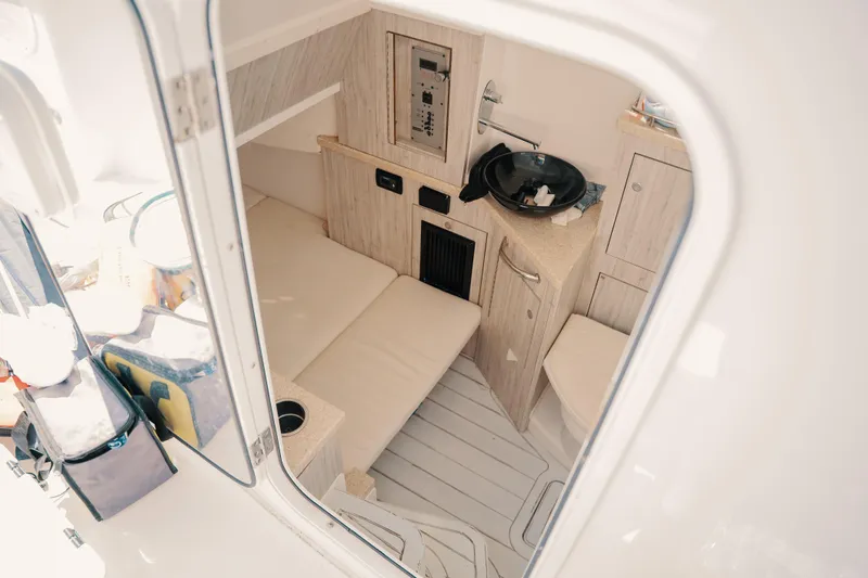 Slide: The Image of Interior of 2019 HCB 42 Siesta boat, featuring a compact cabin with seating and sink. - 5